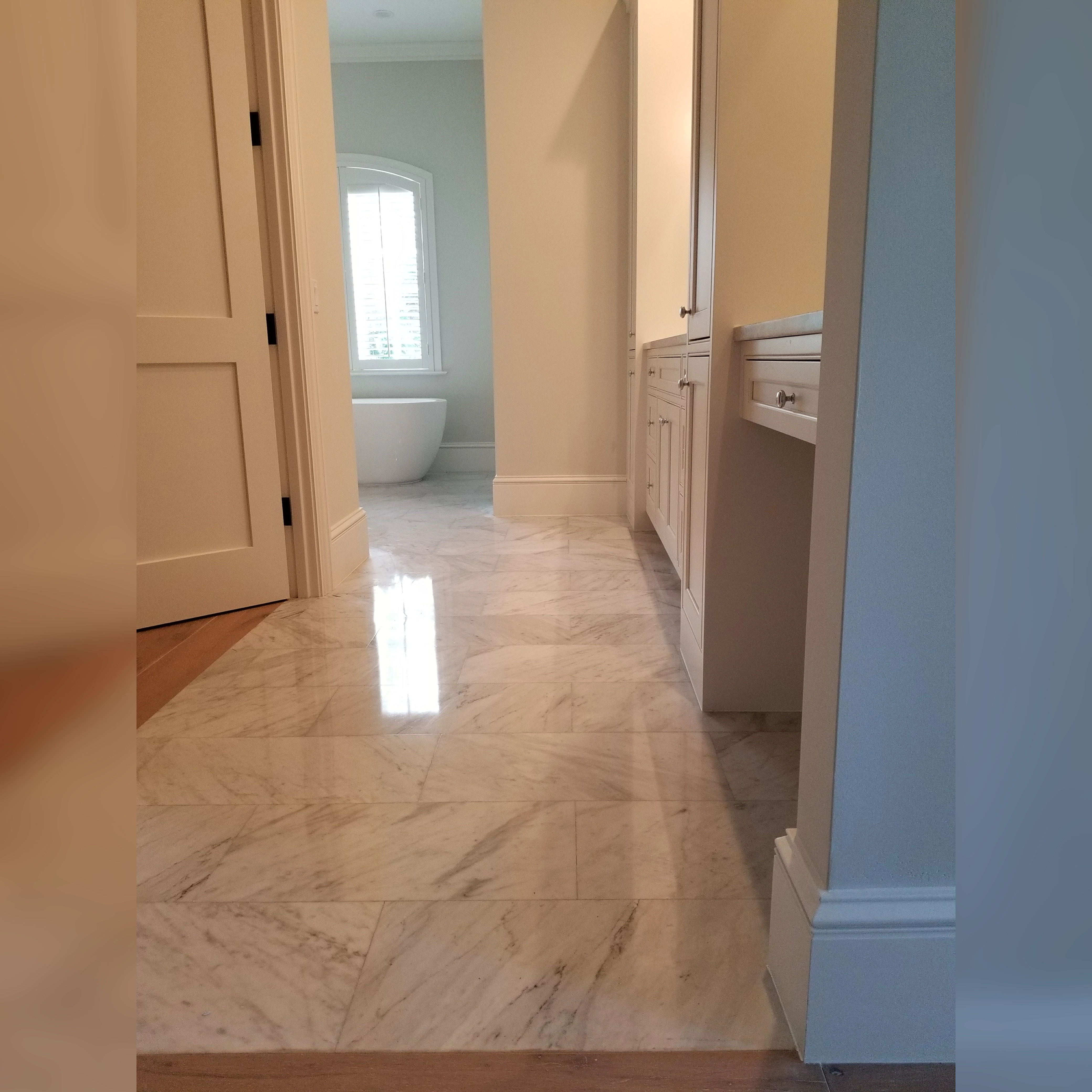 Elegant marble flooring with a polished finish, showcasing natural veining for a timeless and luxurious look.