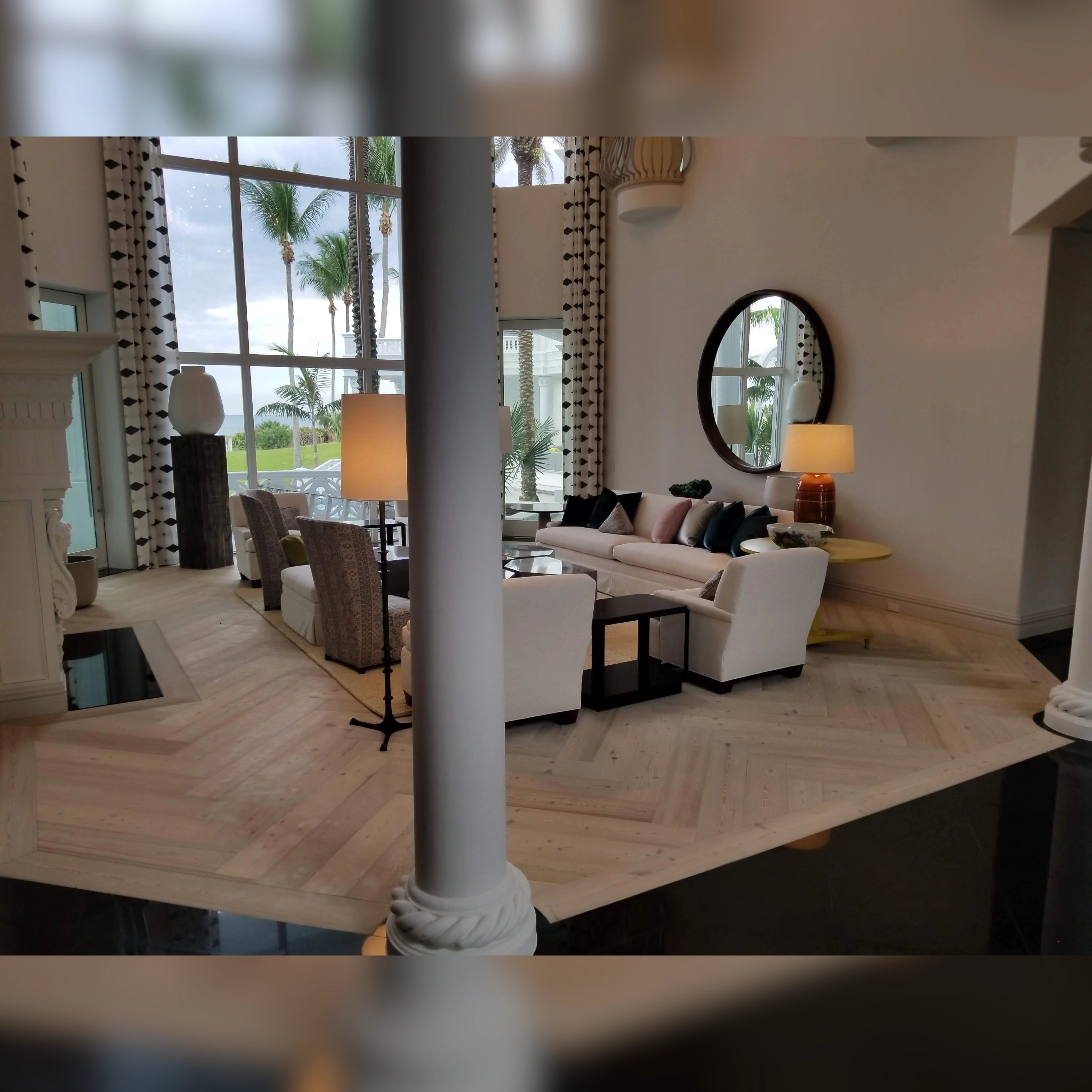 This living room features an engineered wood floor in a diagonal herringbone pattern adding a sophisticated touch to the modern decor.